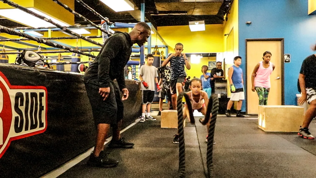 Youth athlete completing battle-rope conditioning
